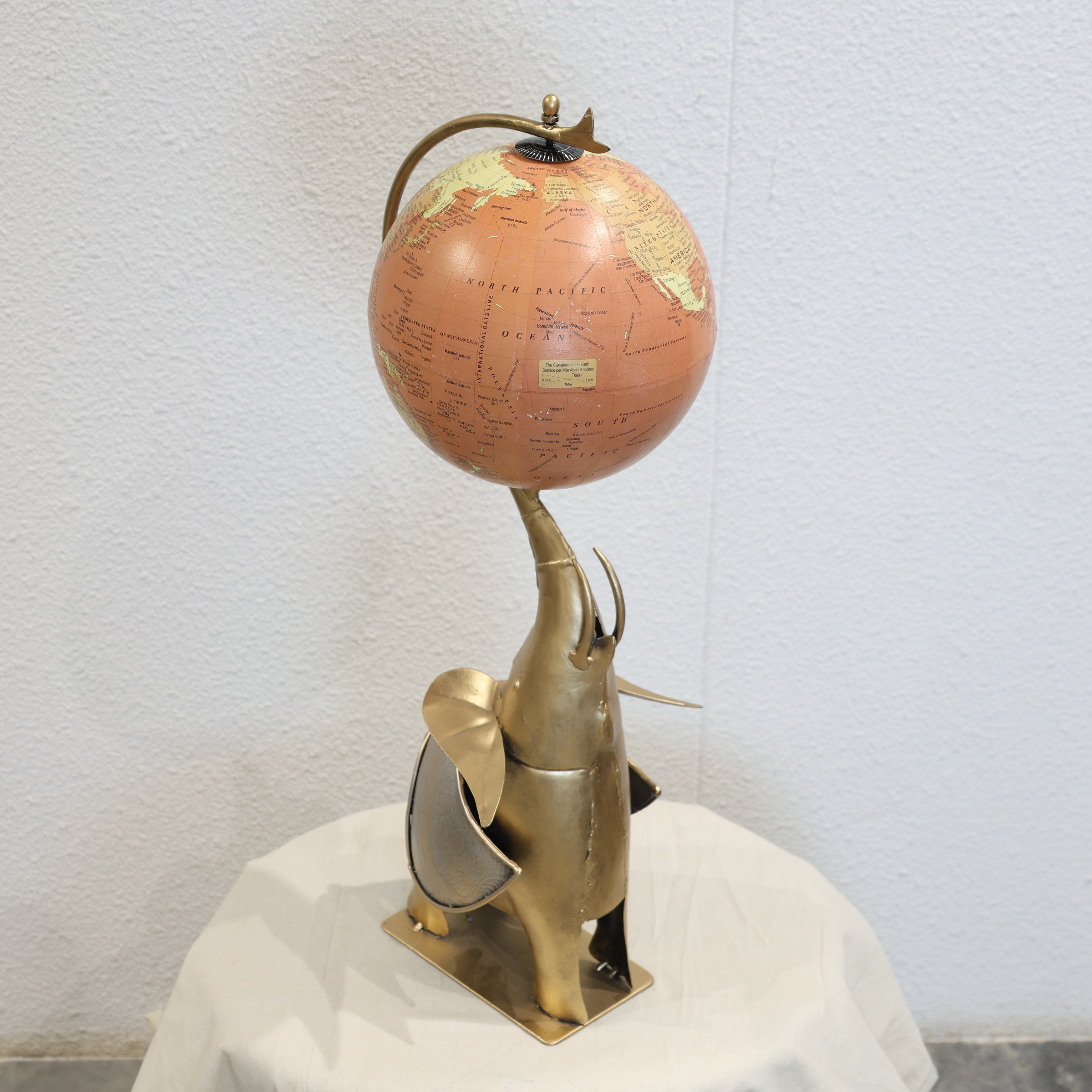 Globe Holding Elephant Sculpture